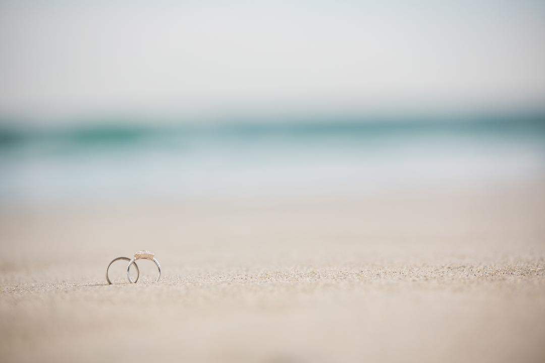 Wedding Rings on Sandy Beach with Ocean in Background - Free Images, Stock Photos and Pictures on Pikwizard.com