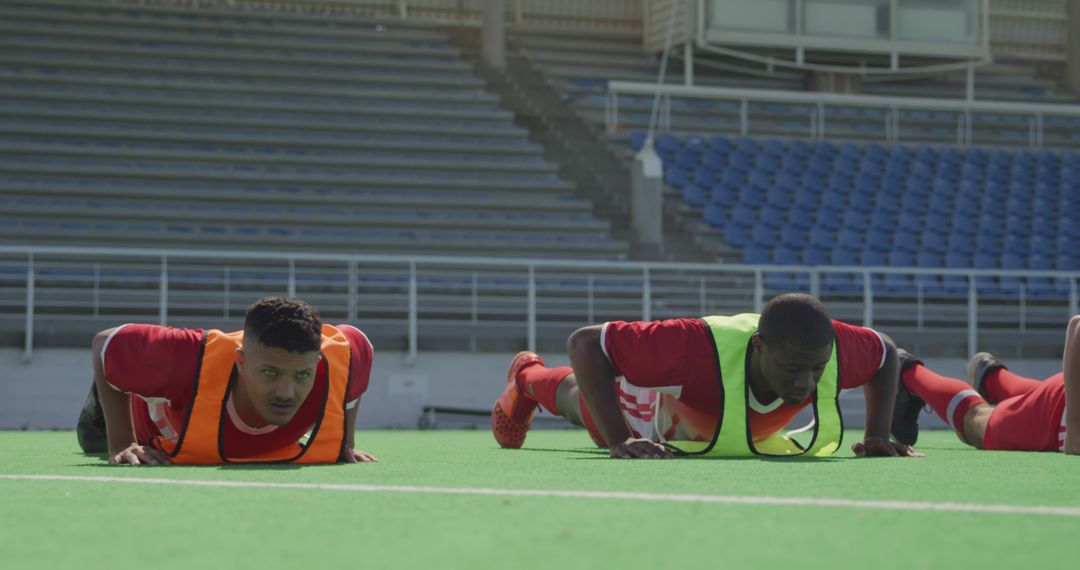 Soccer Players Doing Push-Ups During Training Session on Field - Free Images, Stock Photos and Pictures on Pikwizard.com