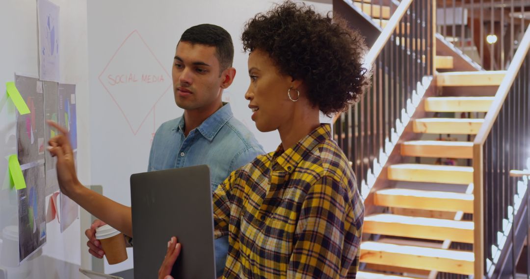 Colleagues Collaborating in Office with Technology and Notes