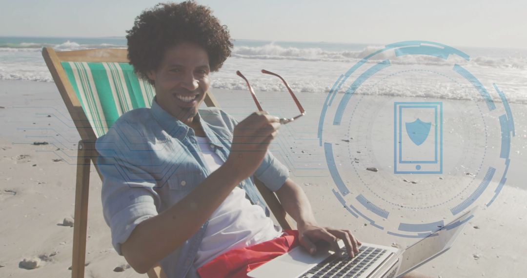 Man Typing on Laptop at Beach with Security Technology Overlay