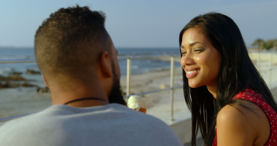 Interracial Couple Enjoying Ice Cream Seaside on Sunny Day