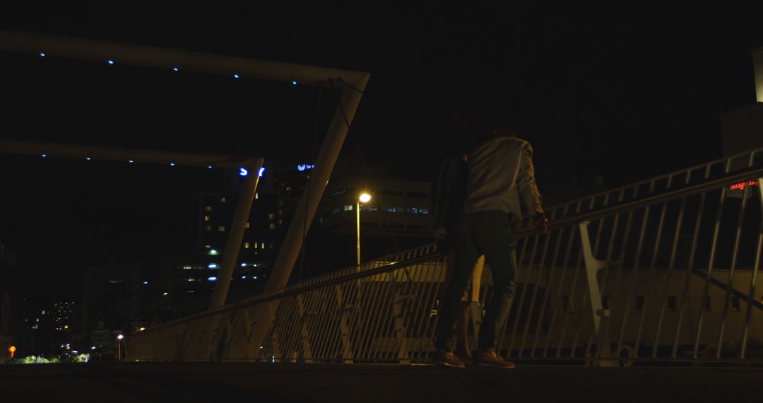 Couple Walking on Urban Bridge at Night - Free Images, Stock Photos and Pictures on Pikwizard.com