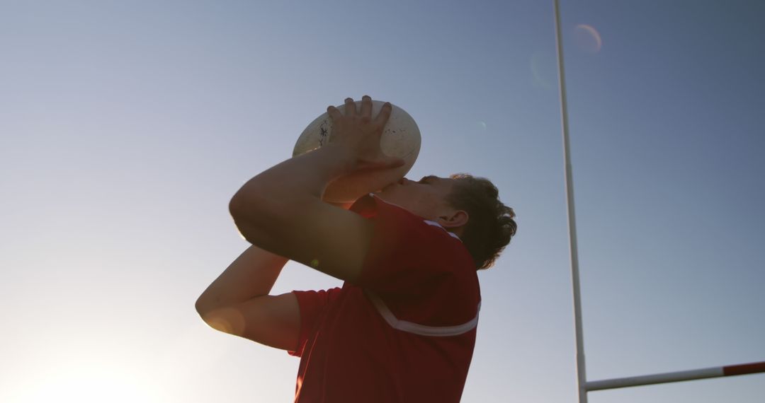 Rugby Player Drinking Water During Sunset - Free Images, Stock Photos and Pictures on Pikwizard.com