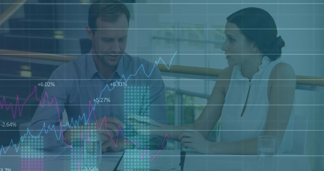 Caucasian Business Team Analyzing Graphs with Data Overlay