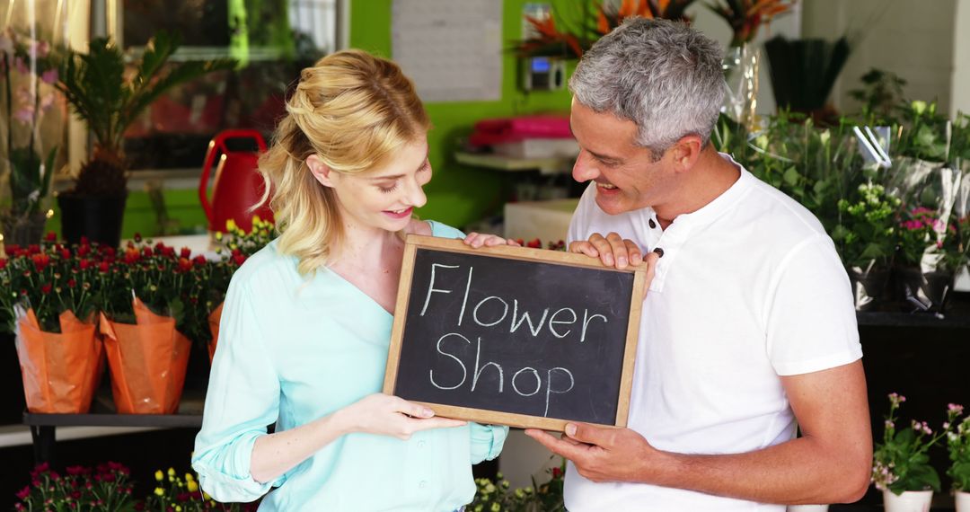 Happy Florist Couple Holding Flower Shop Sign - Free Images, Stock Photos and Pictures on Pikwizard.com