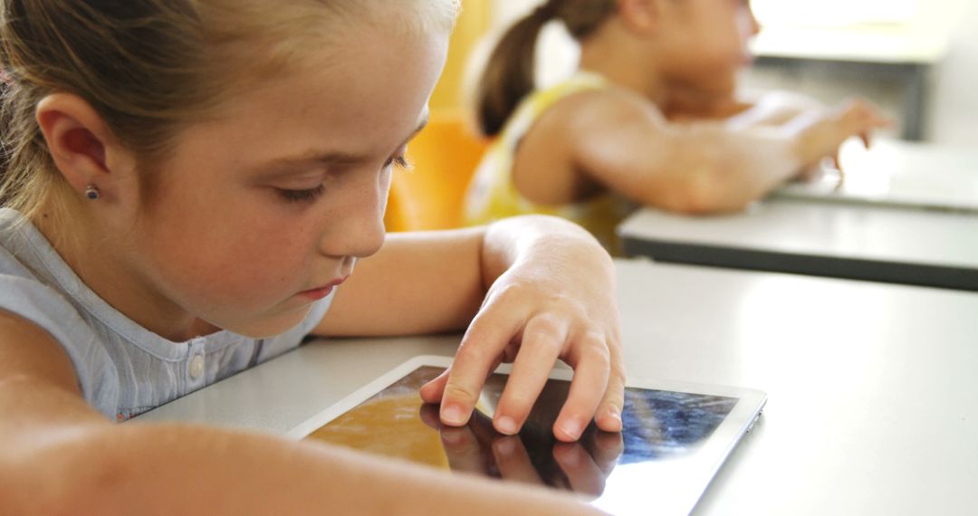 Young Girl Learning on Tablet in Classroom - Free Images, Stock Photos and Pictures on Pikwizard.com