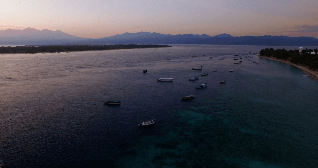 Aerial Transparent Waters with Boats at Twilight