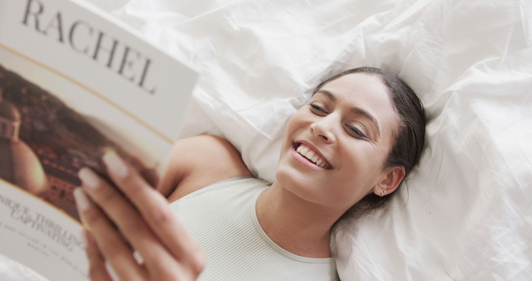 Relaxed Woman Smiling While Reading Magazine in Bed - Free Images, Stock Photos and Pictures on Pikwizard.com