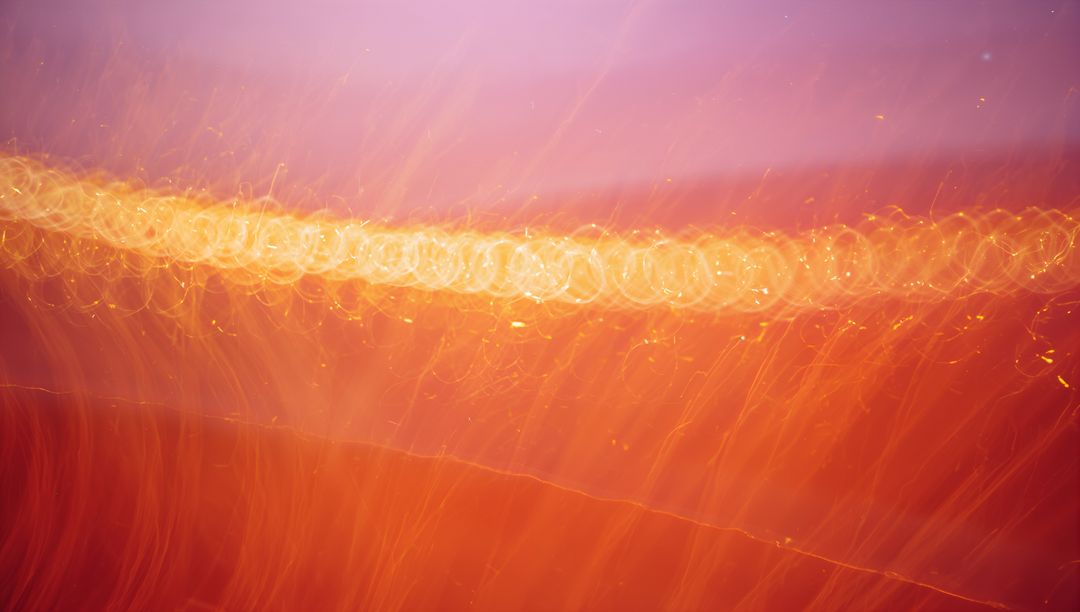 Glowing Gold Bokeh Band with Cascading Orange Light Trails and Soft Purple Gradient