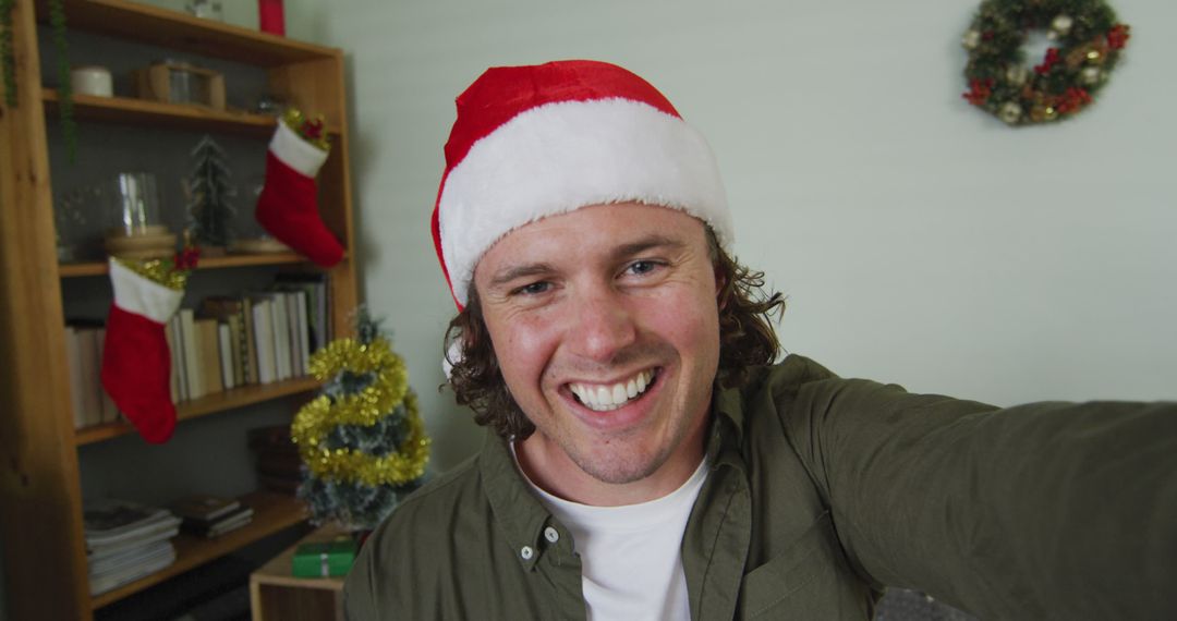 Man in Santa Hat Taking Selfie at Home During Christmas - Free Images, Stock Photos and Pictures on Pikwizard.com