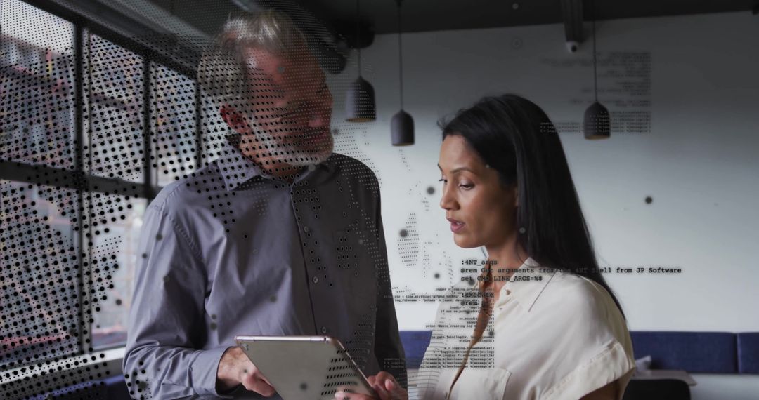 Diverse Colleagues Analyzing Digital Data in Office Meeting