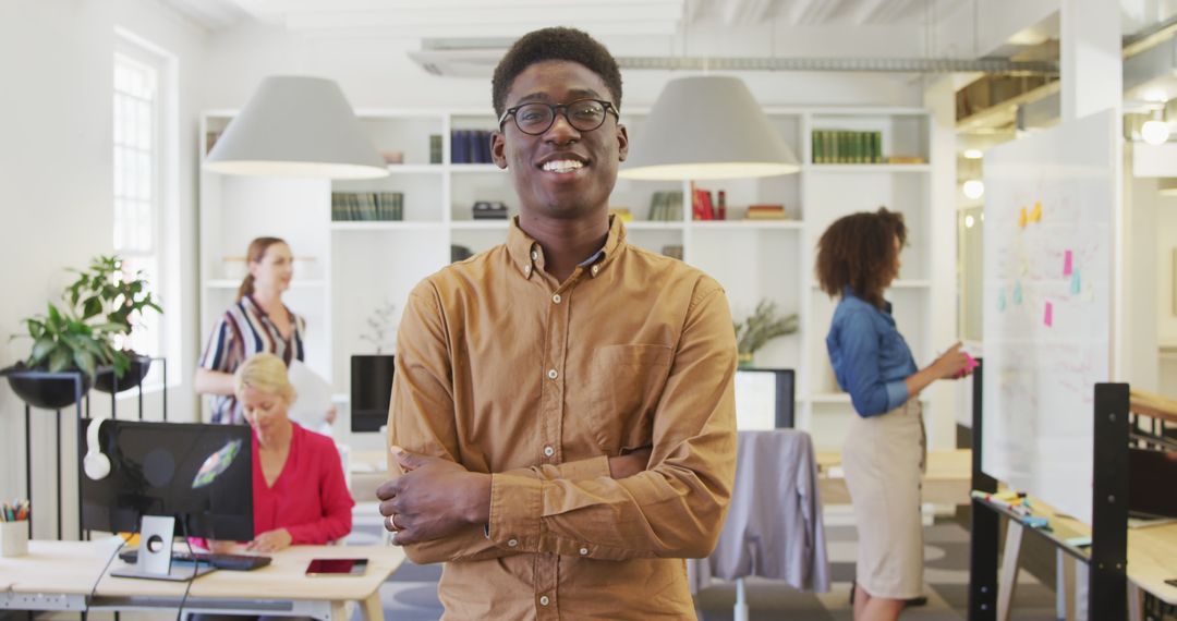 Confident Businessman Smiling in Dynamic Office Environment