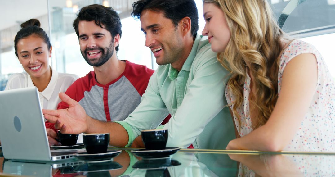 Group of Friends Enjoying Coffee and Laptop in Cafe