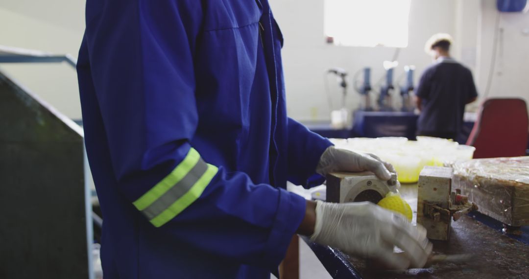 Factory Worker Wearing Protective Gear in Production Line - Free Images, Stock Photos and Pictures on Pikwizard.com