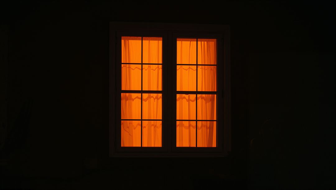 Orange-Hued Window Frame Shining at Night