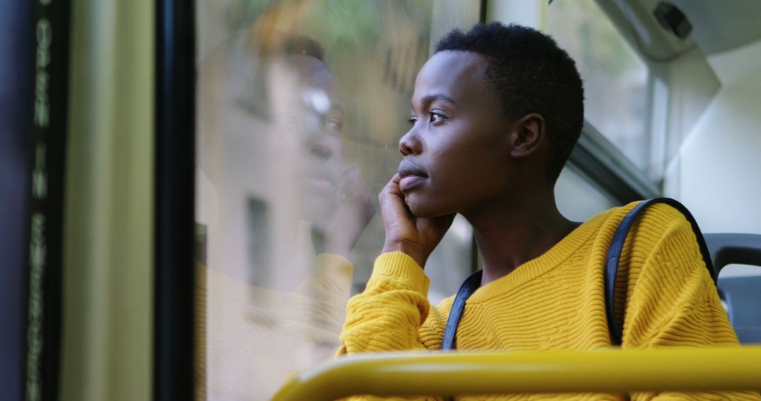 Young Woman in Yellow Sweater Looking Out of Bus Window - Free Images, Stock Photos and Pictures on Pikwizard.com