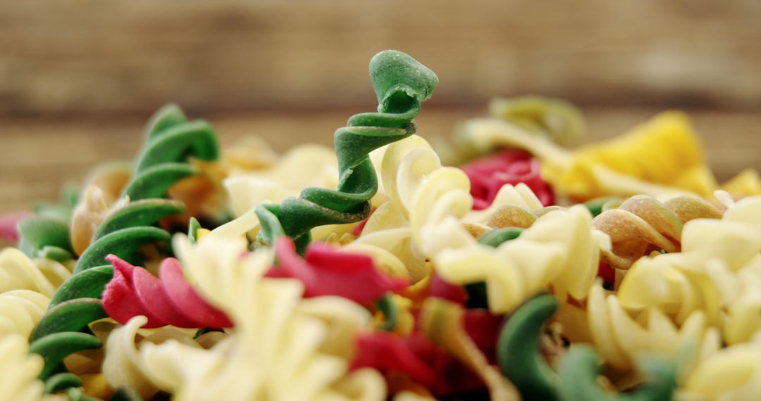 Colorful Fusilli Pasta Pile, Uncooked Rotini on Rustic Surface - Free Images, Stock Photos and Pictures on Pikwizard.com