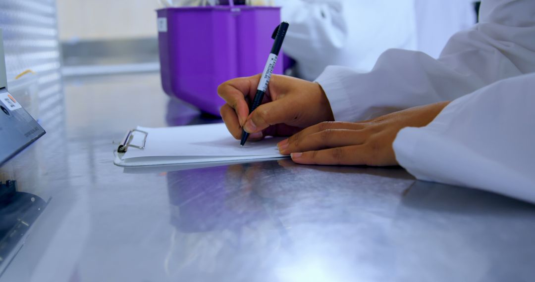 Scientist Recording Data on Clipboard in Laboratory - Free Images, Stock Photos and Pictures on Pikwizard.com