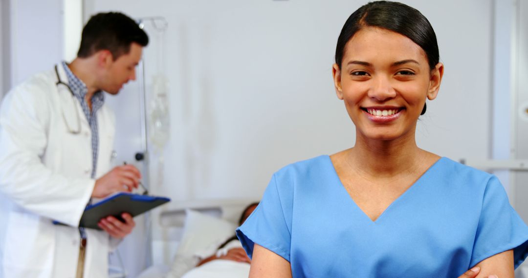 Smiling Female Nurse in Hospital Ward with Doctor and Patient in Background - Free Images, Stock Photos and Pictures on Pikwizard.com