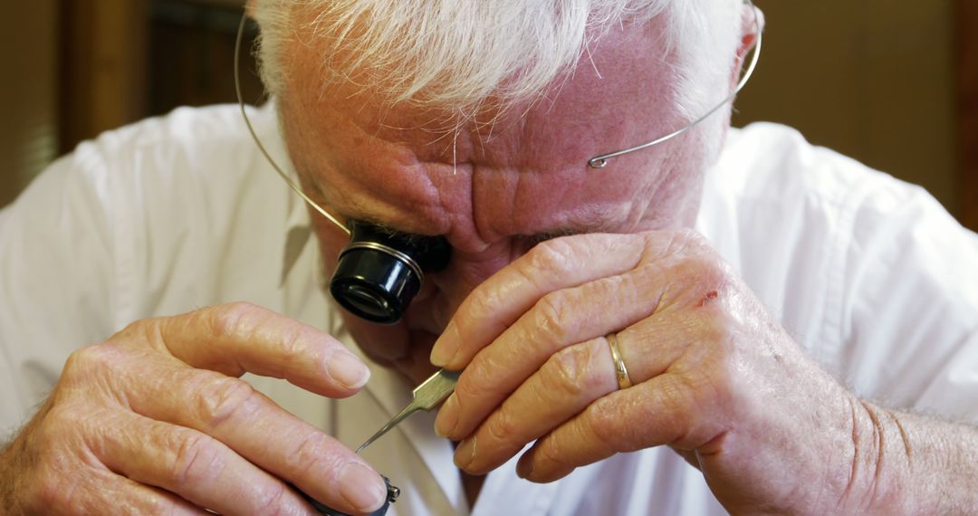 Elderly Watchmaker Repairing Watch with Magnifying Loupe and Tools - Free Images, Stock Photos and Pictures on Pikwizard.com