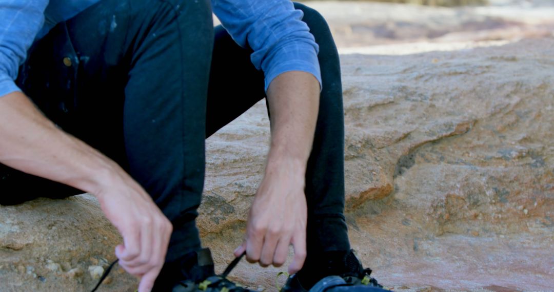 Male Hiker Lacing Climbing Shoes Outdoors on Rocky Terrain - Free Images, Stock Photos and Pictures on Pikwizard.com