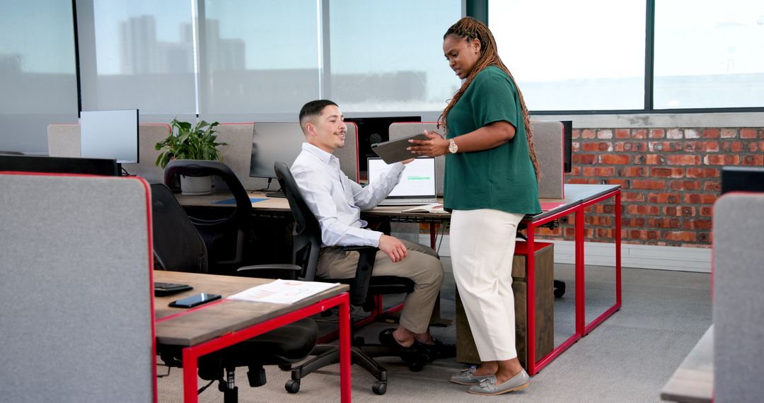 Office Colleagues Collaborating at Computer Desk Planning Project