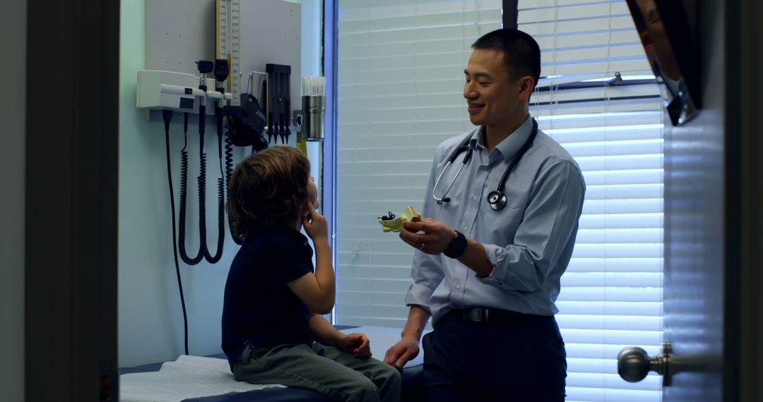 Pediatric Doctor Interacting with Young Patient in Examination Room - Free Images, Stock Photos and Pictures on Pikwizard.com