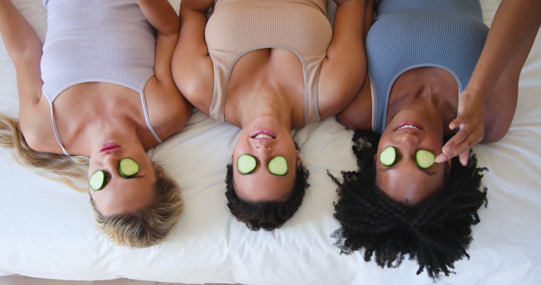 Diverse Friends Enjoying Spa Day with Cucumber Relaxation