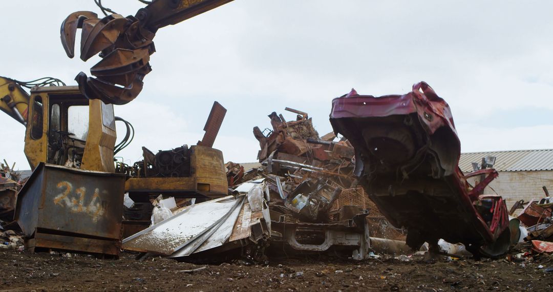 Industrial Scrap Yard with Heavy Machinery Moving Metal - Free Images, Stock Photos and Pictures on Pikwizard.com