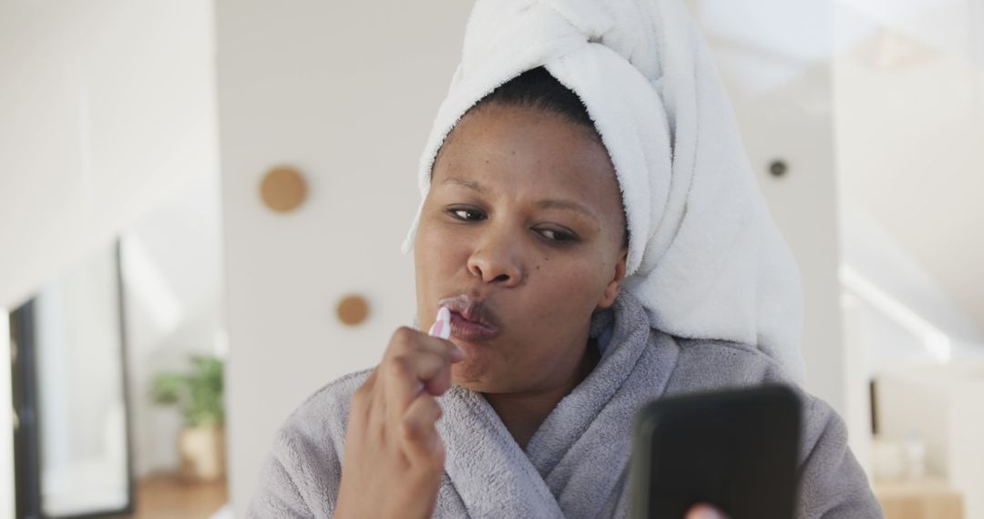 Woman Brushing Teeth While Using Smartphone at Home - Free Images, Stock Photos and Pictures on Pikwizard.com