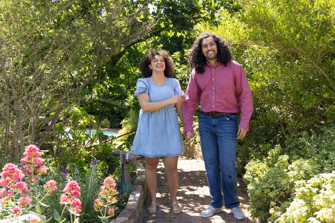 Couple Strolling Hand in Hand Through Lush Garden