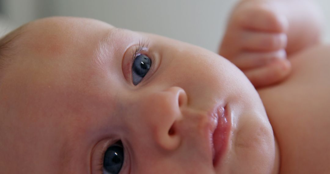 Close-Up of Newborn Baby with Big Blue Eyes Looking Up - Free Images, Stock Photos and Pictures on Pikwizard.com