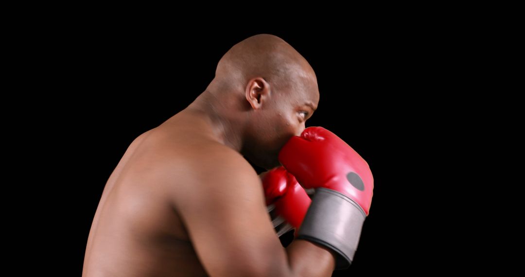 Boxer Training with Red Gloves Isolated on Black - Free Images, Stock Photos and Pictures on Pikwizard.com