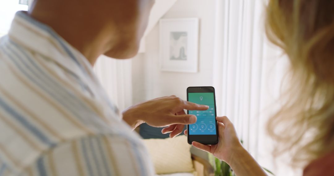 Couple Utilizing Home Automation in Modern Living Space