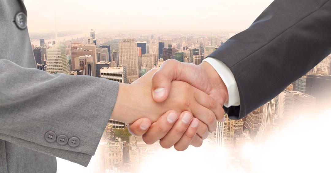 Close-up of handshake with buildings in background - Free Images, Stock Photos and Pictures on Pikwizard.com