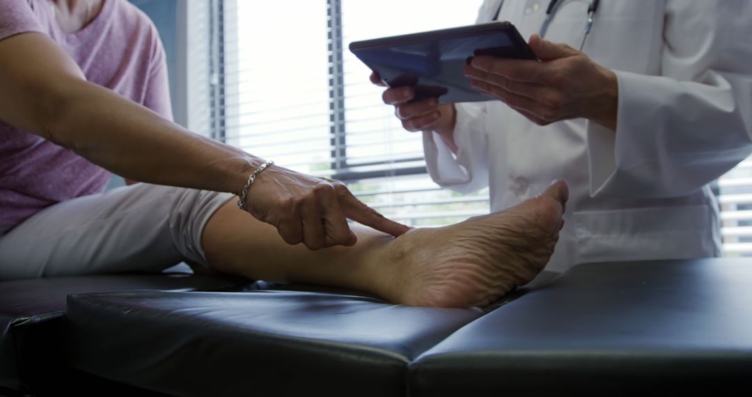 Doctor Examining Patient's Leg with Digital Tablet in Medical Office - Free Images, Stock Photos and Pictures on Pikwizard.com