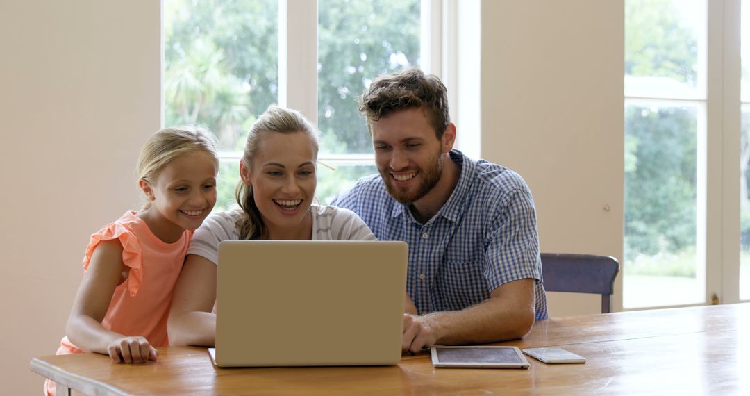 Smiling Family Using Laptop Together At Home - Free Images, Stock Photos and Pictures on Pikwizard.com