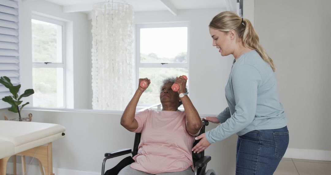 Physical therapist assists senior woman in wheelchair doing arm exercises - Free Images, Stock Photos and Pictures on Pikwizard.com