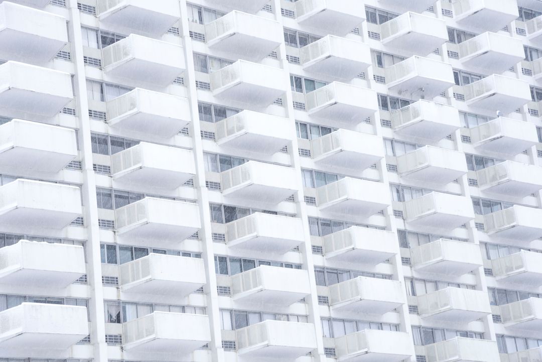 Abstract perspective of identical white condo balconies on skyscraper