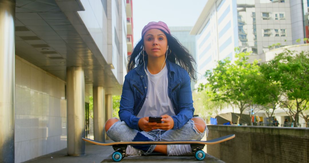 Young Woman On Skateboard Using Smartphone Urban Scene - Free Images, Stock Photos and Pictures on Pikwizard.com