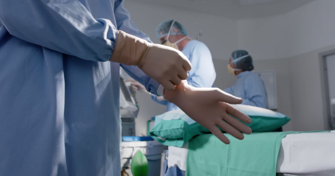 Surgeon Preparing for Surgery with Latex Gloves in Operating Room - Free Images, Stock Photos and Pictures on Pikwizard.com