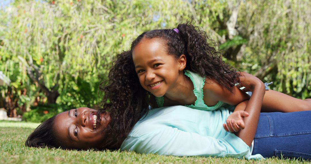 Mother and Daughter Smiling on Grass Outdoors in Nature - Free Images, Stock Photos and Pictures on Pikwizard.com