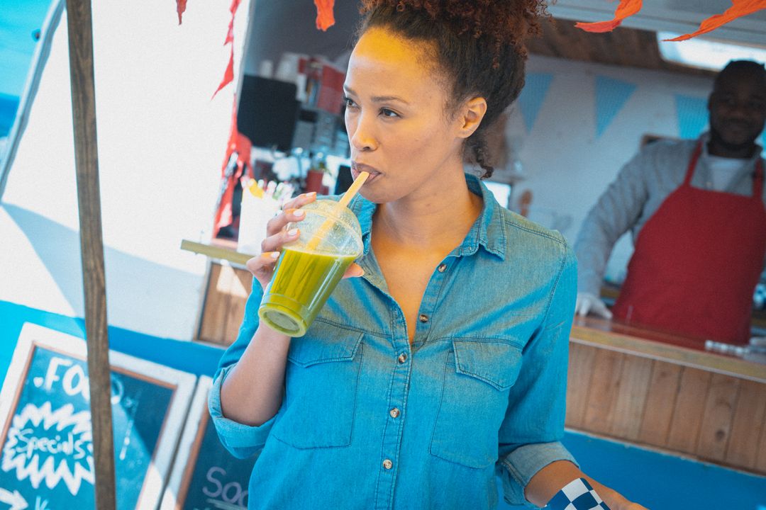 Biracial Woman Enjoying Healthy Drink at Food Truck - Free Images, Stock Photos and Pictures on Pikwizard.com