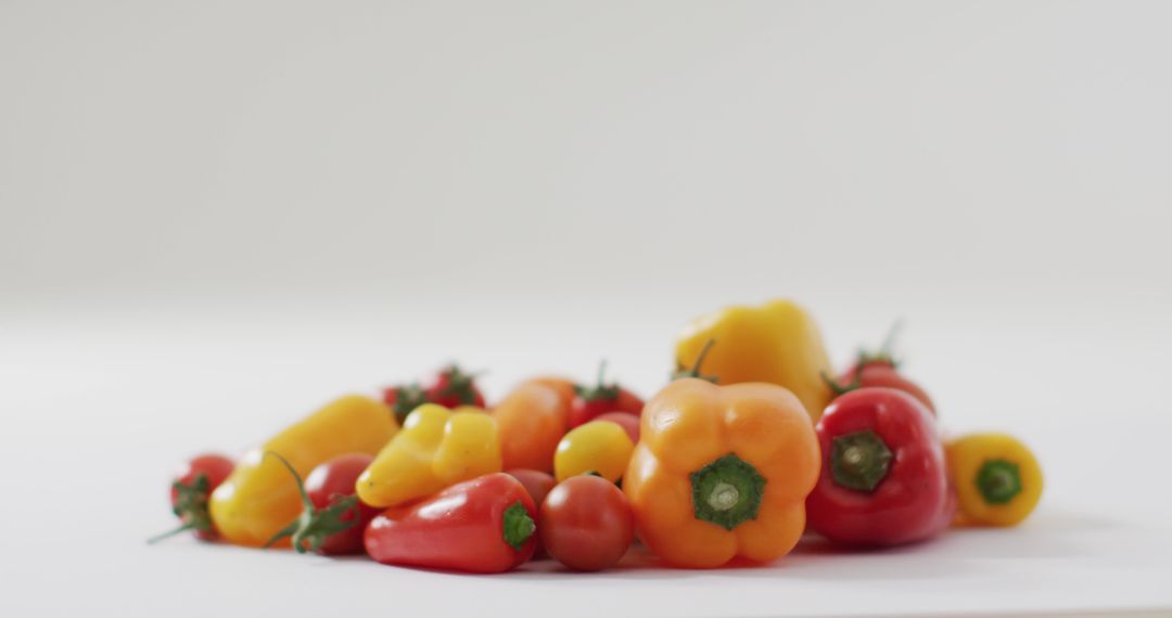 Fresh Assortment of Peppers and Tomatoes on White Background