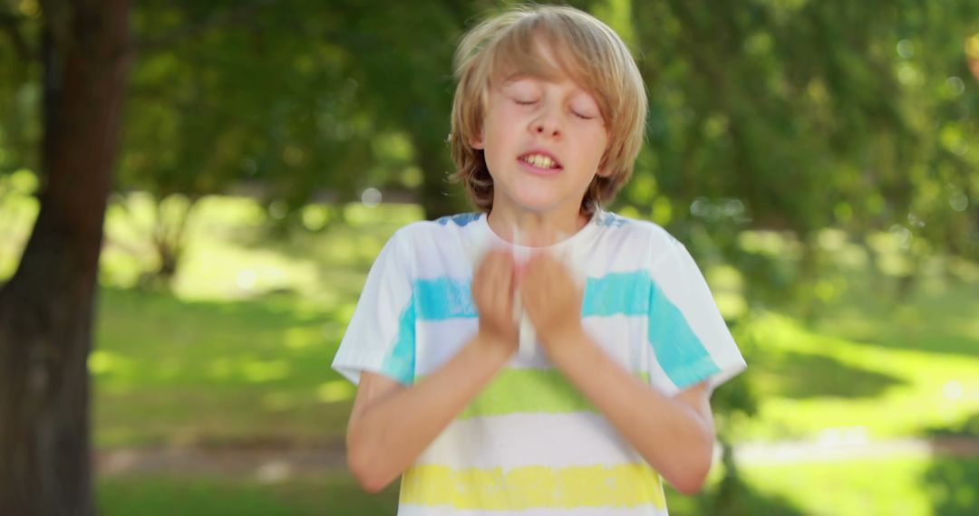 Blonde Boy Sneezing in Park During Sunny Day - Free Images, Stock Photos and Pictures on Pikwizard.com