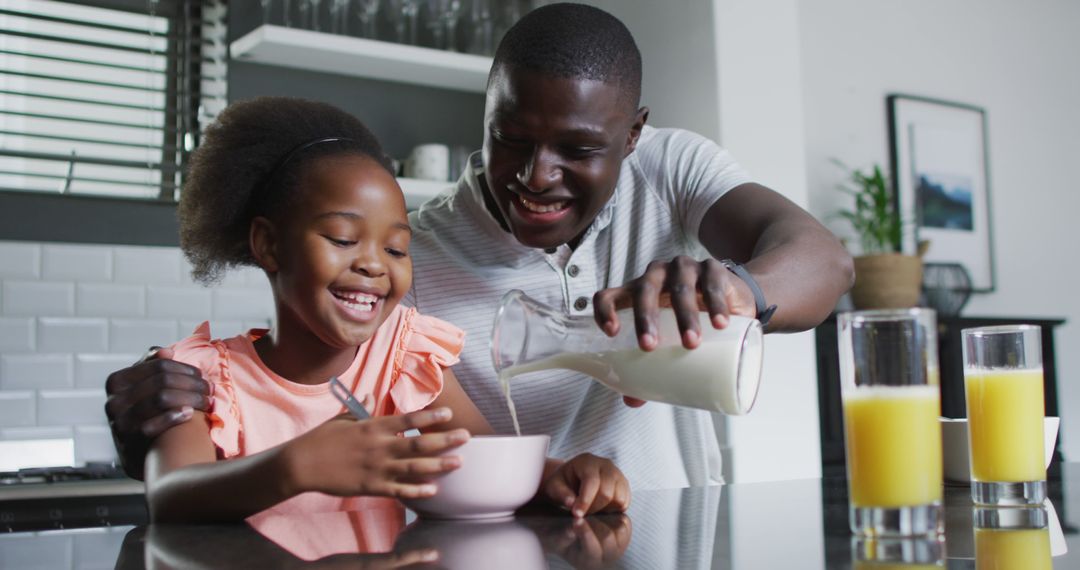 Image of african american father and daughter eating breakfast - Free Images, Stock Photos and Pictures on Pikwizard.com