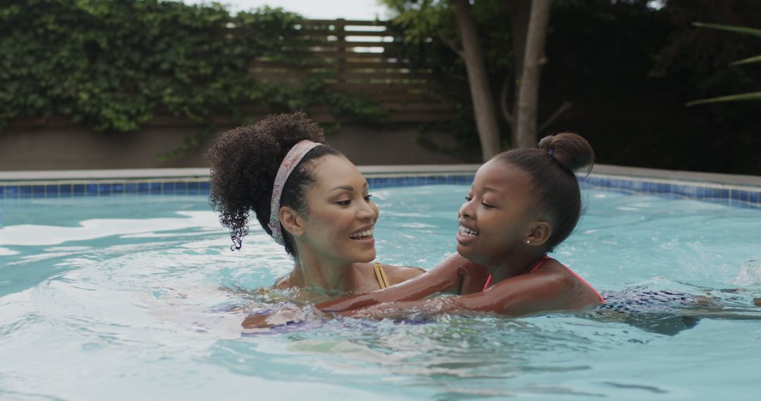 Mother and Daughter Enjoying Time in Pool - Free Images, Stock Photos and Pictures on Pikwizard.com