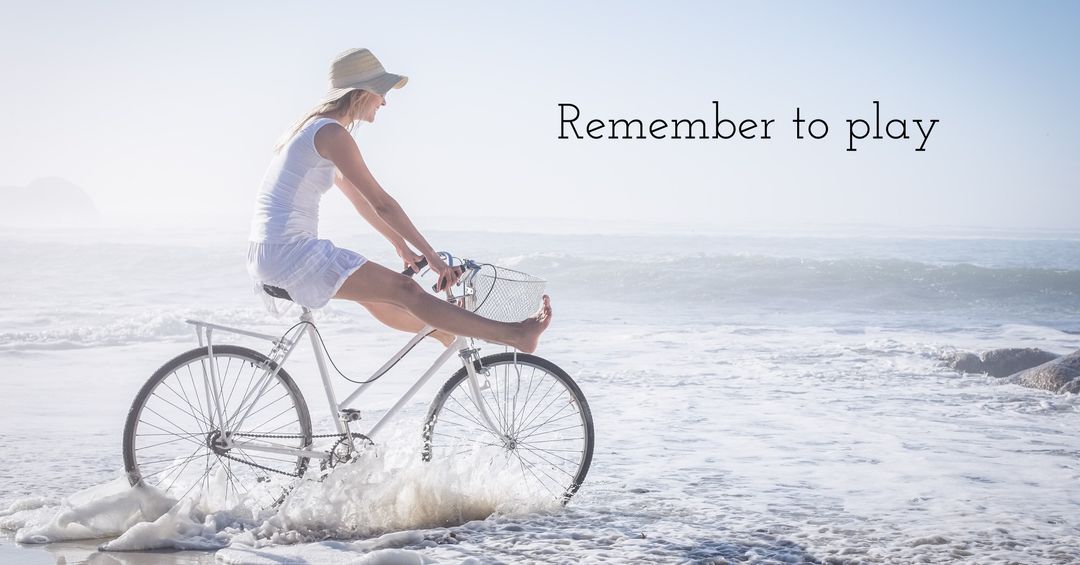 Carefree woman bicycling through waves, embracing summer joy