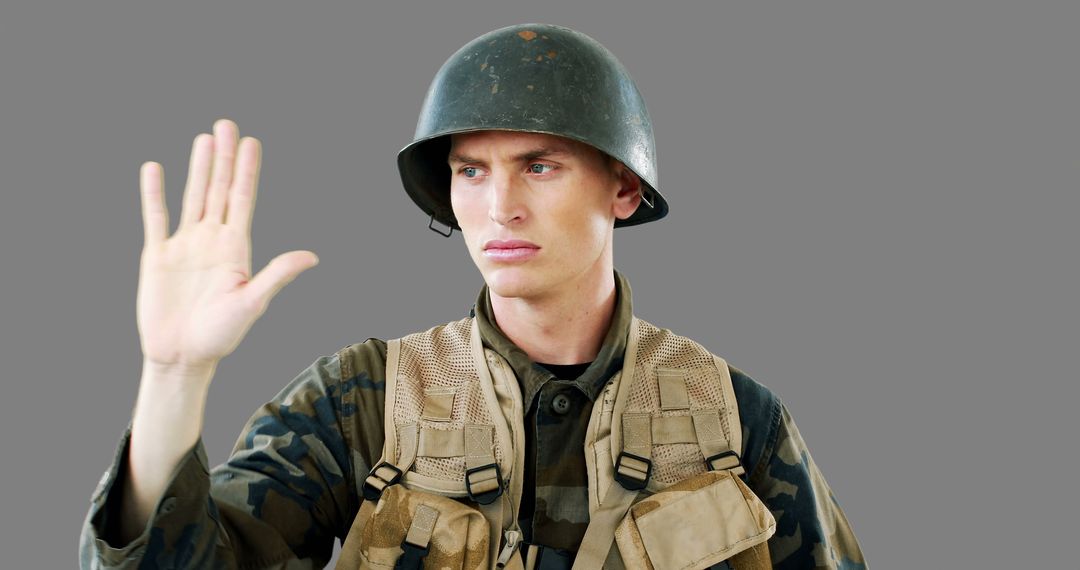 Soldier Giving Hand Gesture in Military Uniform - Free Images, Stock Photos and Pictures on Pikwizard.com