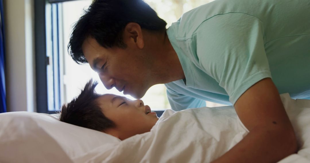 Father Kissing Son Goodnight in Cozy Bedroom - Free Images, Stock Photos and Pictures on Pikwizard.com